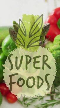 Super foods text over colorful vegetables including bell peppers, broccoli, and zucchini