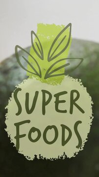 Super foods text animation over avocado, orange slice, and seeds on white background