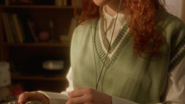 Caucasian teenage girl inserting CD into portable player, putting on headphones, and dancing in retro room. Clip is ideal for nostalgia marketing, music streaming ads, or lifestyle campaigns