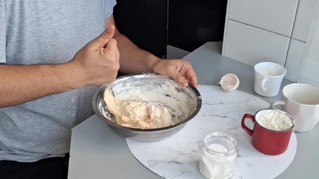 Mixing dough in a kitchen at home while preparing for baking