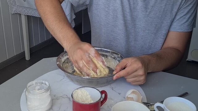 Kneading dough in a kitchen with simple tools and ingredients