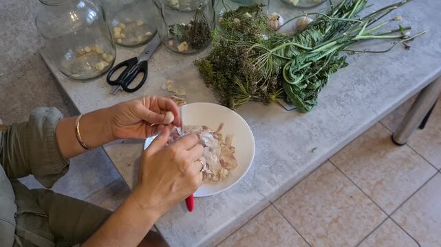 Preparing fresh herbs and garlic in a kitchen setting