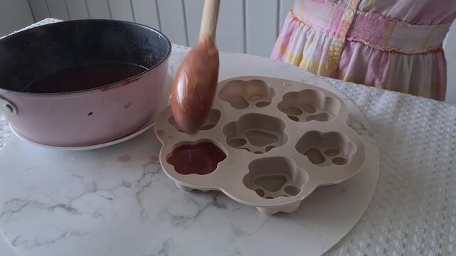 Making fruit jelly in a kitchen with a a silicone mold on the table