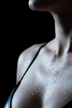 Woman's sweating body showing wet skin drops