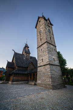 Karpacz, Dolnoslaskie, Poland - 29 July 2026: View of the historic wooden Wang Church and its stone bell tower in the evening light.