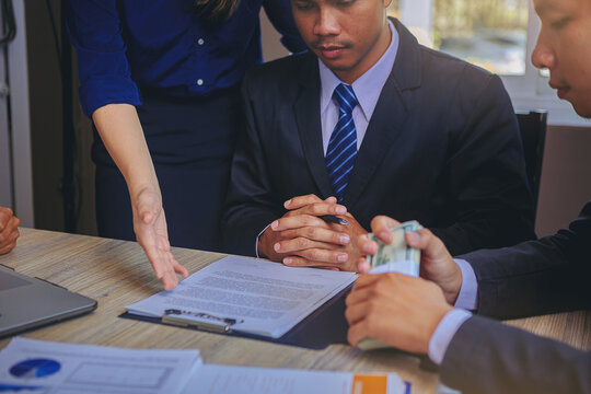 Business peoples reading documents at meeting, business partner considering contract terms before signing checking legal contract law conditions. Selected focus