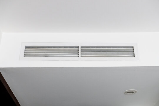 Linear slot ceiling air conditioner vent grille on a white ceiling