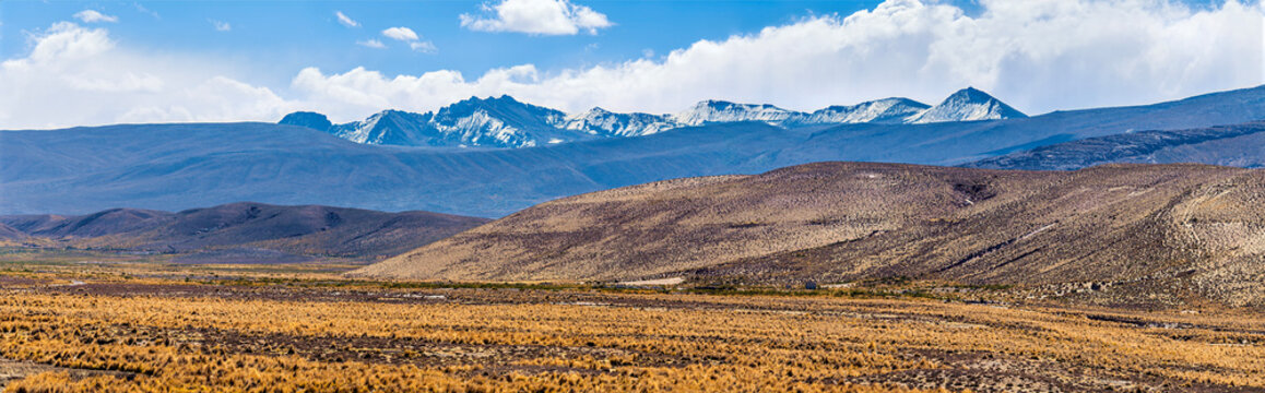 A panorama view of the arid high altitude plateau of the Andes Mountains region on the route from Arequipa toward the Colca Canyon in southern Peru in the dry season
