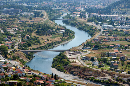 Aerial view of the Moraca River flowing through the urban landscape of Podgorica, Podgorica Municipality, Montenegro.