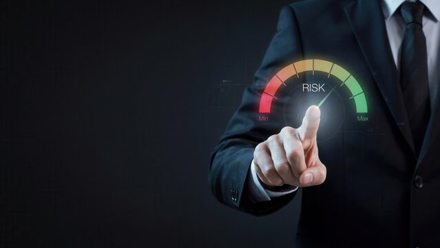 Professional businessman in dark formal suit touches a glowing digital risk gauge interface showing levels from minimum to maximum intensity