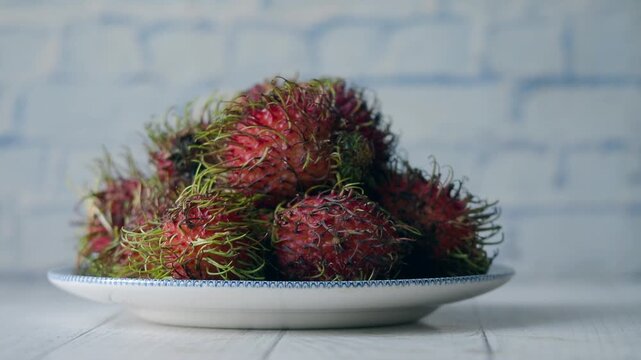 Rambutan fruit on a plate in a kitchen setting