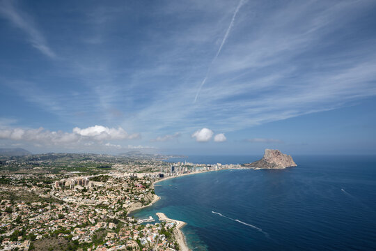 Panoramic view of Calpe and its Mediterranean bay from Morro de Toix, with Penon de Ifach rising beyond the urban coastline on Spain's Costa Blanca.