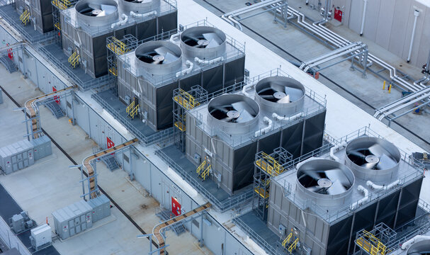 Aerial view of industrial cooling towers with large rotating fans on the roof of a data center facility, New Albany, Ohio, United States.