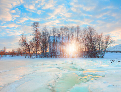 Beautiful winter landscape with snow-covered many house at sunset - Tromso, Norway