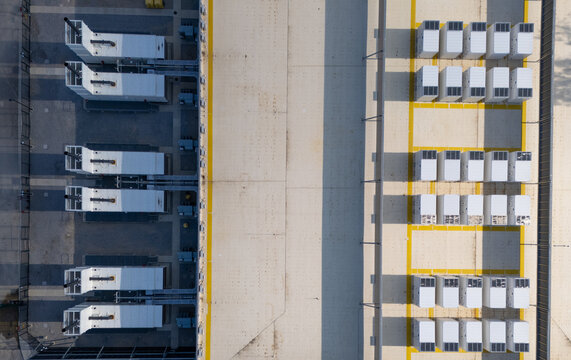 Aerial view of a data center with rows of white cooling units and yellow safety markings on the concrete ground in Columbus, Ohio, United States.