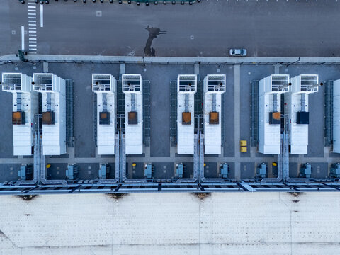Aerial view of a modern data center facility featuring rows of cooling units and electrical infrastructure on a concrete site in Columbus, Ohio, United States.