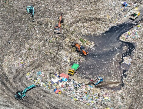 Aerial view of the Aminbazar Landfill with heavy machinery and excavators working on the vast waste site in Aminbazar, Dhaka Division, Bangladesh.
