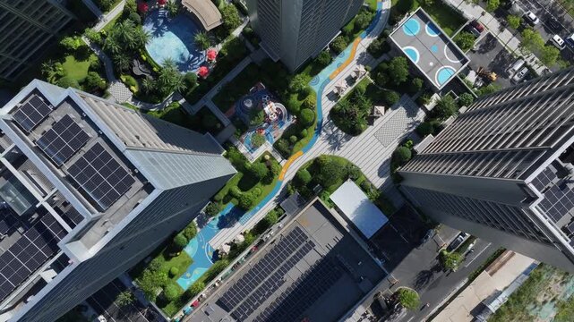 Aerial view of modern high-rise buildings and green swimming pool landscape