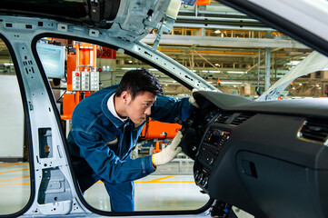 Asian Factory Worker Inspecting Car Interior on Automotive Assembly Production Line © jeson