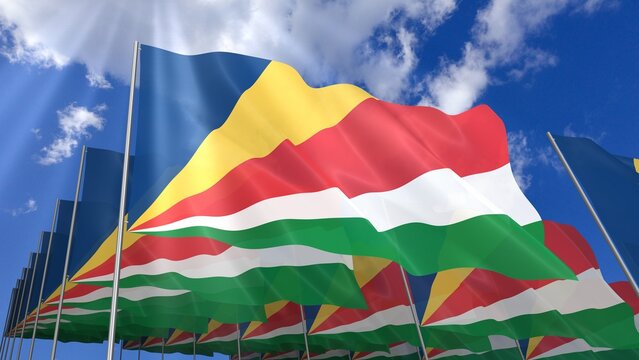 Multiple Seychelles flags waving on blue sky