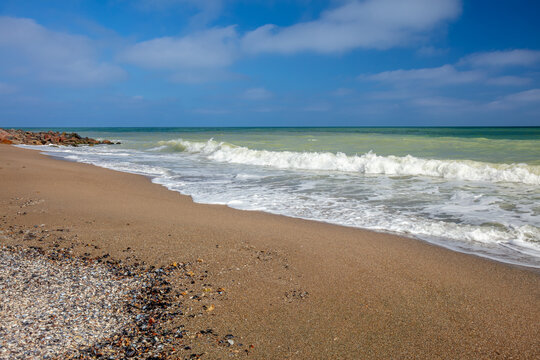 Surfing Wave on a Sandy Beach