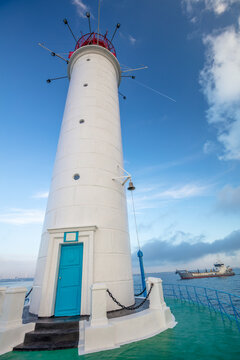 Old Lighthouse and Cargo Ship