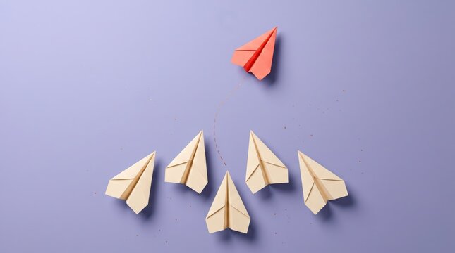 Paper airplanes following leader on purple background
