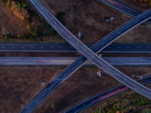 Aerial view of the highway interchange featuring intersecting roads, asphalt surfaces, and surrounding landscape in Sausheim, Grand Est, France.