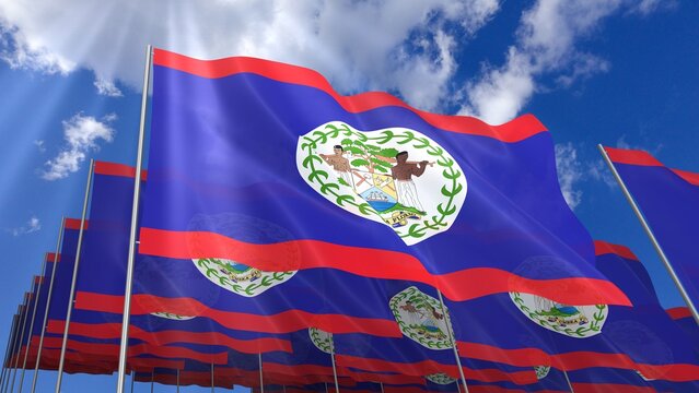 Multiple Belize flags waving on blue sky
