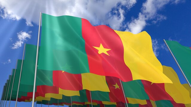 Multiple Cameroon flags waving on blue sky