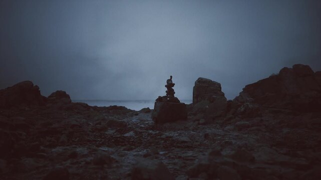 Dark and threatening horizon over rough coastal terrain. Bleak seaside panorama featuring stormladen sky and uneven rocky seashore formations