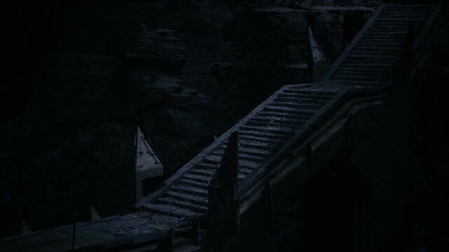 Dim stone bridge crossing chasm under faint light, tattered banners on broken poles, crumbling parapet, wind whispering through empty flagstones, somber mood