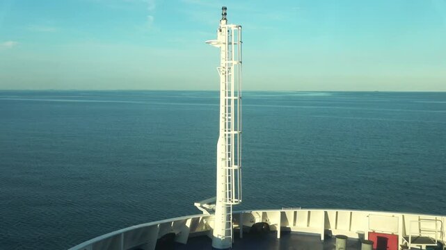 Cargo ship bow cruising on calm ocean water