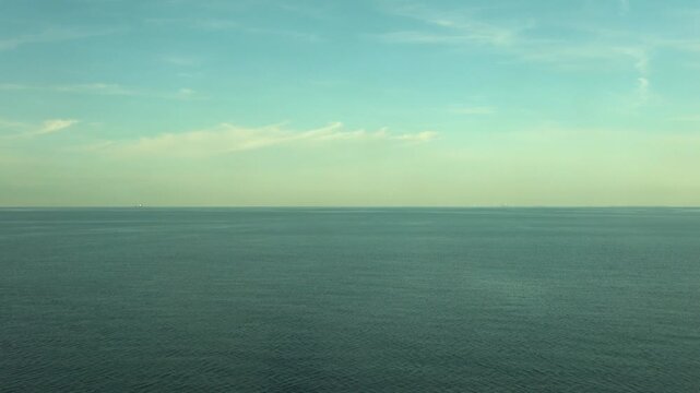 Calm ocean surface under a blue sky