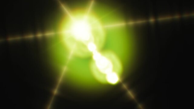 A glowing green lens flare effect flashes against a dark black background.