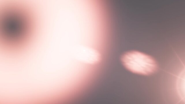 Bright pink lens flare effect with glowing lights in a dark background.