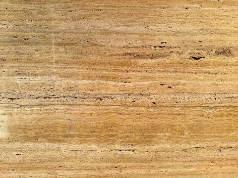 Beige travertine marble stone texture background full frame natural porous limestone wall tile surface pattern rough sandstone floor design element seamless architecture material detail close up.