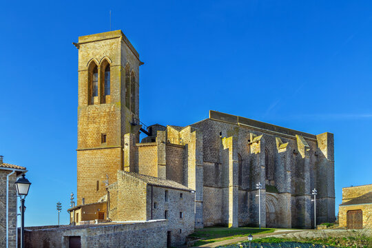 Church of San Saturnino in Artajona, Spain, side view. Medieval gothic religious architecture with stone walls and tower