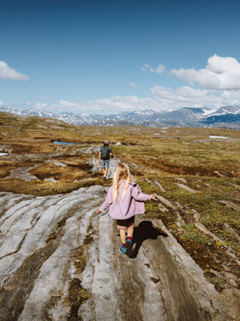Family travel child and parent on hiking vacations outdoor together in Norway - father and daughter walking in mountains explore Lahko national park trails, healthy lifestyle active people tour