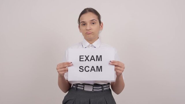 Sad Indian Schoolgirl Standing with EXAM SCAM Poster