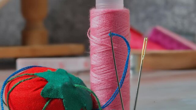 craft sewing tools: needle, bobbin, thread