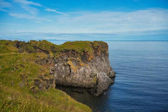 A picturesque cliff coastline between the villages of Hellnar and Arnarstapi in western Iceland.