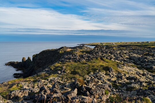 A picturesque cliff coastline between the villages of Hellnar and Arnarstapi in western Iceland.