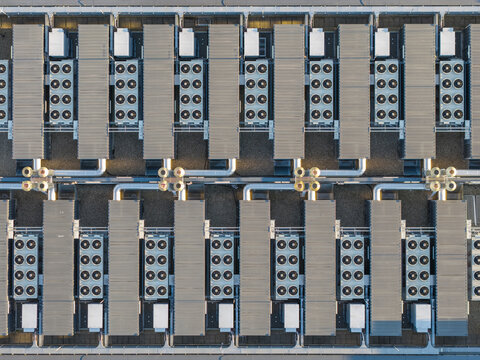Aerial view of industrial HVAC cooling units arranged in geometric rows on a rooftop in Frankfurt am Main, Hessen, Germany.