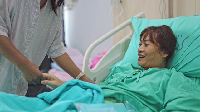 Doctor checking patient health condition in hospital ward