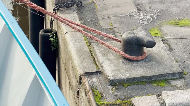 A sturdy mooring rope secures a ship to a quay on the Neva River in Saint Petersburg. This safe scene evokes calm and peaceful feelings during a pleasant journey.