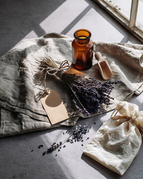 Lavender zero waste still life amber bottle on linen cloth