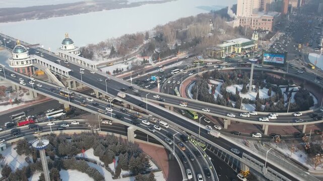 Snowy Multilevel Highway Interchange and Frozen Waterfront in Harbin, China