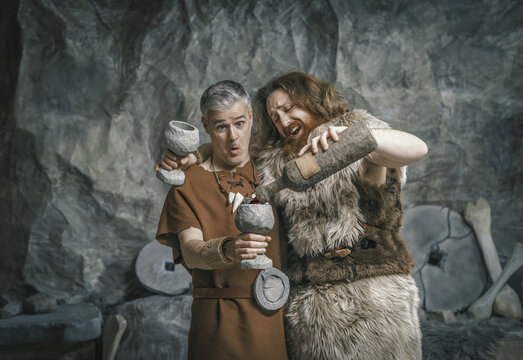 Funny Stone Age people drinking alcohol and having fun