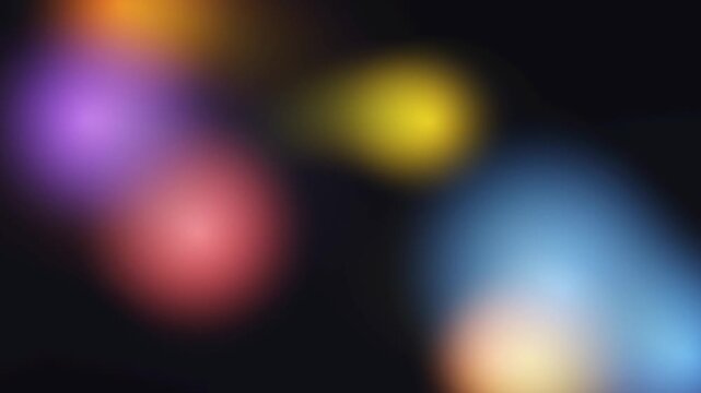 Blurred colorful bokeh lights floating on dark background